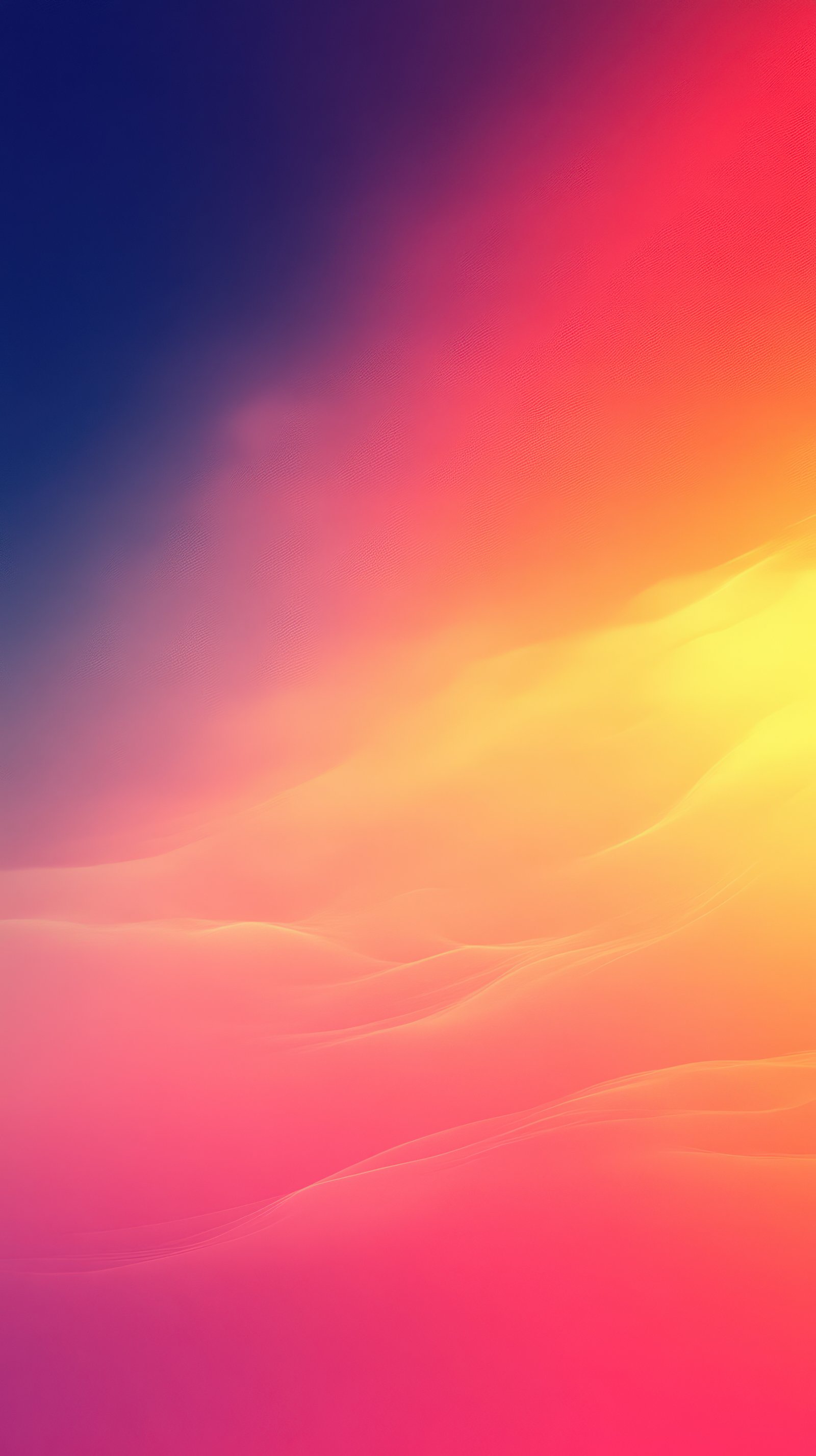 Vibrant sunset over undulating sand dunes creates an ethereal atmosphere in a desert landscape